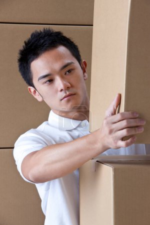 Photo for Asian delivery man with cardboard boxes - Royalty Free Image