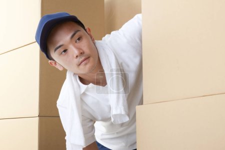 Photo for Man carrying boxes in warehouse - Royalty Free Image