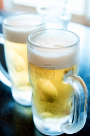 Photo for Cold beer in ice glasses on background, close up - Royalty Free Image