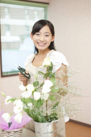 Téléchargez les photos : Fleuriste à des cours d'arrangement de fleurs. Floristique en master classes ou cours - en image libre de droit