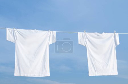 Photo for Clothes drying in line against blue sky - Royalty Free Image