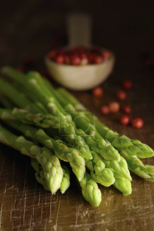 Photo for A bunch of asparagus and tomatoes on a table - Royalty Free Image