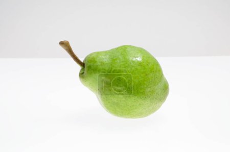 Photo for Close-up view of ripe green pear on white background - Royalty Free Image
