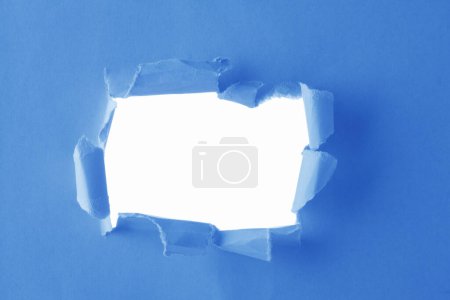 Photo for Hole in torn paper on a white background - Royalty Free Image