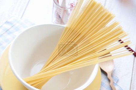 Photo for Raw spaghetti on the kitchen on background, close up - Royalty Free Image