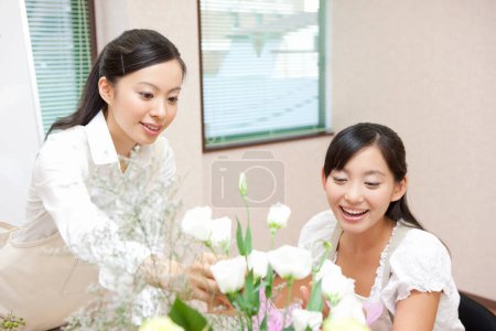 Téléchargez les photos : Fleuristes à des cours d'arrangement de fleurs. Floristique en master classes ou cours - en image libre de droit