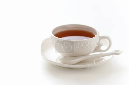 Téléchargez les photos : Tasse de thé avec une cuillère sur le fond, gros plan - en image libre de droit