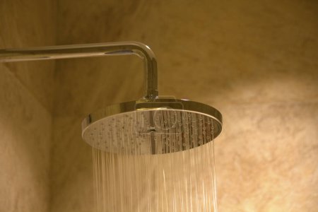 Photo for Shower head with flowing water in bathroom - Royalty Free Image