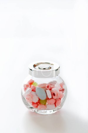 Photo for Candies in a glass jar on a white background - Royalty Free Image
