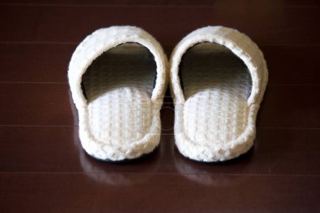 Photo for White slippers on a gray background, close up - Royalty Free Image