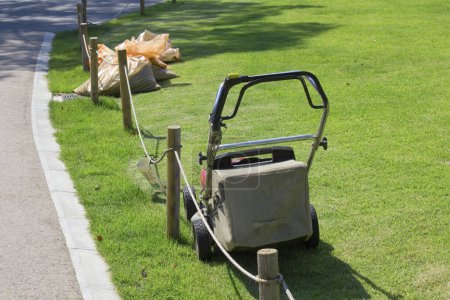 Photo for Lawn mower in green grass. lawn mower in the garden on the lawn. - Royalty Free Image