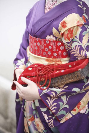 Photo for Young Asian woman wearing traditional Japanese costume, mid section - Royalty Free Image