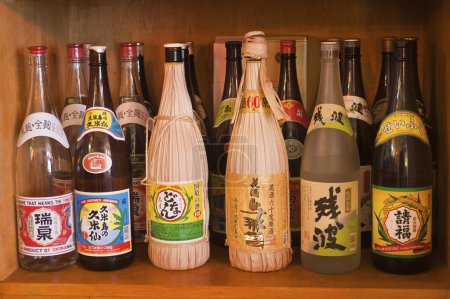 Téléchargez les photos : Divers types de boissons alcoolisées de style japonais dans des bouteilles au restaurant au Japon - en image libre de droit