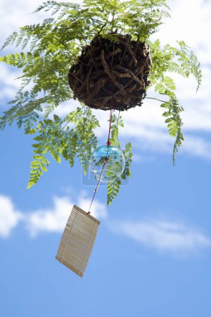 Photo for Close up view of beautiful Japanese wind chime and leaves - Royalty Free Image