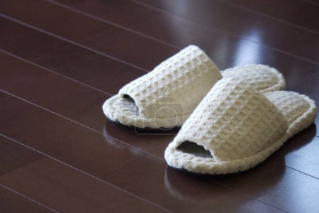Photo for White slippers on a gray background, close up - Royalty Free Image