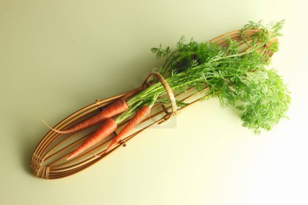 Photo for A bunch of carrots tied on background, close up - Royalty Free Image