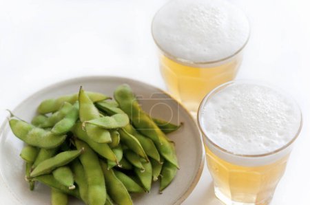 Foto de Jarras con cerveza fría y judías verdes, de cerca - Imagen libre de derechos