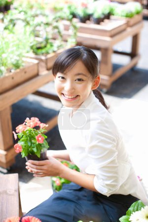 Photo for Portrait of young Japanese woman florist working in shop - Royalty Free Image