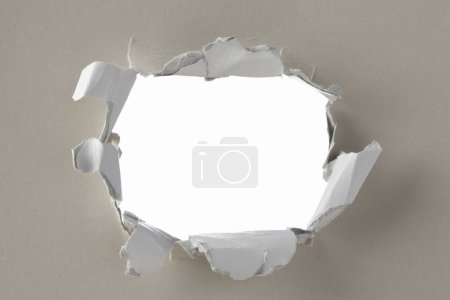 Photo for Hole in torn paper on a white background - Royalty Free Image