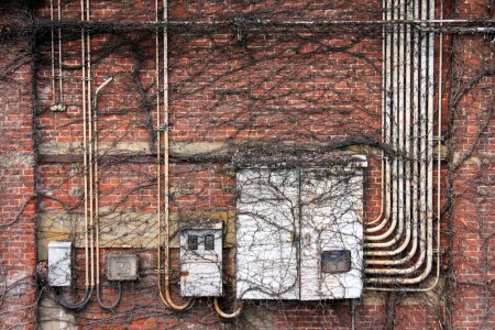 Photo for Old white tubes against red brickwall - Royalty Free Image