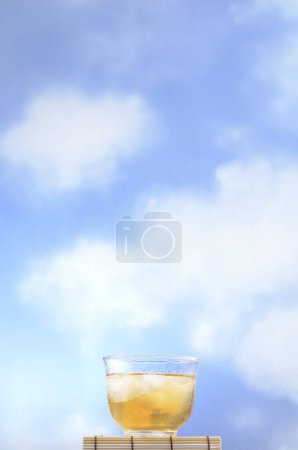 Photo for Glass of iced tea on sky background, close up - Royalty Free Image