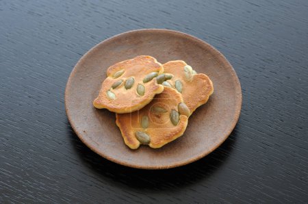 Photo for Crispy cookies with pumpkin seeds on plate - Royalty Free Image