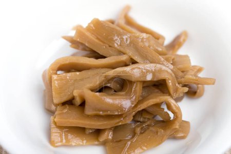 Menma. bamboo shoots boiled, sliced, fermented, dried or preserved in salt, then soaked in hot water and sea salt.