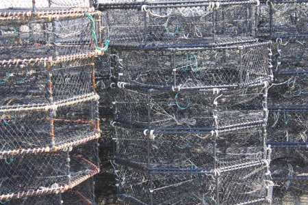 Foto de Trampas de cangrejo en puerto. redes de pesca apiladas - Imagen libre de derechos