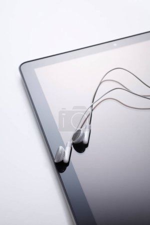 Photo for Headphones and tablet on table - Royalty Free Image