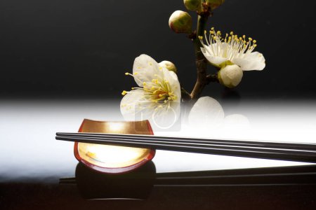 Close up view of chopsticks placed on resting base