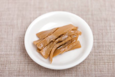 tasty Menma. bamboo shoots boiled, sliced, fermented, dried or preserved in salt, then soaked in hot water and sea salt.