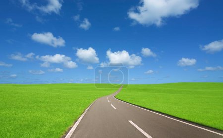 Photo for Asphalt road and green grass field with blue sky and white clouds - Royalty Free Image