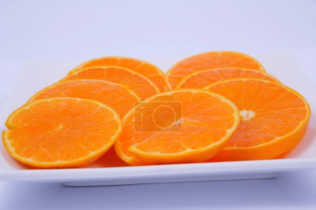 Photo for Plate of sliced oranges isolated on white background - Royalty Free Image