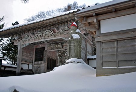 scenic shot of ancient Japanese temple in snow covered Hokkaido, Japan