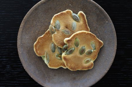 Photo for Crispy cookies with pumpkin seeds on plate - Royalty Free Image