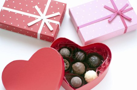 Photo for Heart-shaped box with chocolate candies, close up view - Royalty Free Image
