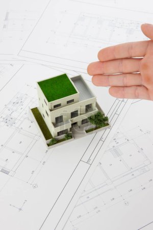 Téléchargez les photos : Close-up view of architect presenting model of house on a white background - en image libre de droit