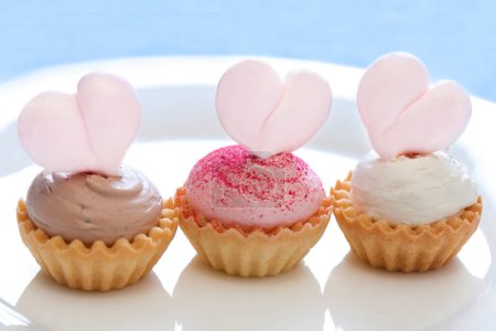 Photo for Delicious cupcakes decorated with pink hearts, closeup - Royalty Free Image