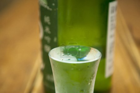 Sake  glass and bottle on background, close up
