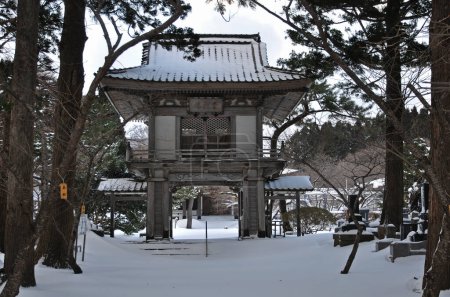 scenic shot of ancient Japanese temple in snow covered Hokkaido, Japan