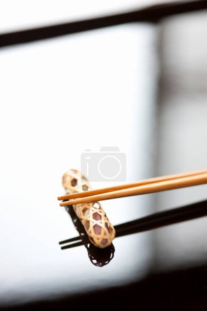 Photo for Close up view of chopsticks placed on resting base - Royalty Free Image