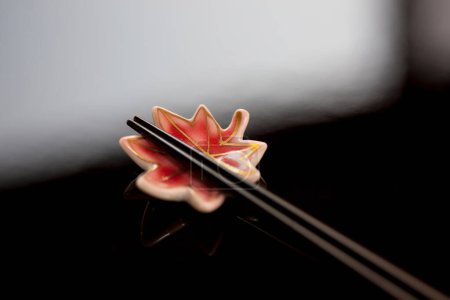 Photo for Close up view of chopsticks placed on resting base - Royalty Free Image
