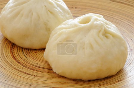 Photo for Japanese Nikumans (Steamed Pork Buns) on bamboo plate - Royalty Free Image