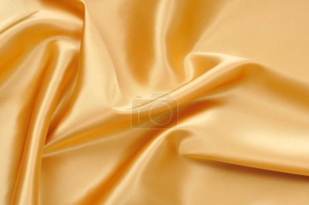 Téléchargez les photos : Soie dorée élégante lisse comme fond - en image libre de droit
