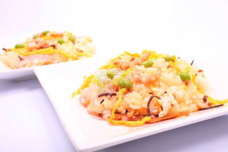 Photo for Delicious rice and shrimps with vegetables on white plates - Royalty Free Image