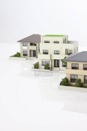 Photo for Small models of houses on white background, mortgage concept - Royalty Free Image