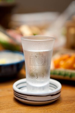 japanese Sake  in glass and food  on background, close up