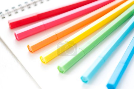 Photo for Colored felt-tip pens and notebook  on  background - Royalty Free Image