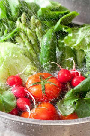 Photo for Close-up view of fresh vegetables washing with water in sink - Royalty Free Image