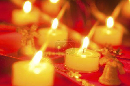 Photo for Burning candles on red, christmas decoration on table - Royalty Free Image